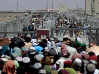 Menschenmassen stehen vor einem Drahtzaun an der Grenze Afghanistans