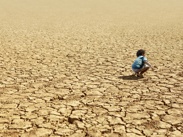 Child Playing on Dry Parched Desert Land